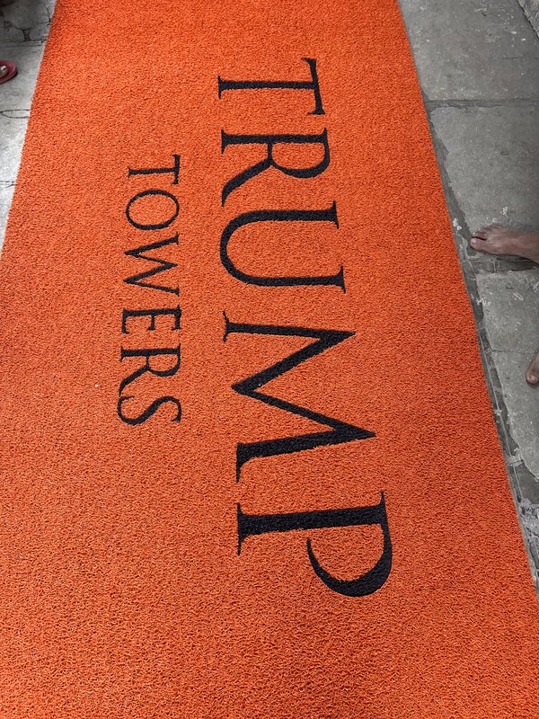 Custom logo branded entrance mat installed at a premium tower entrance